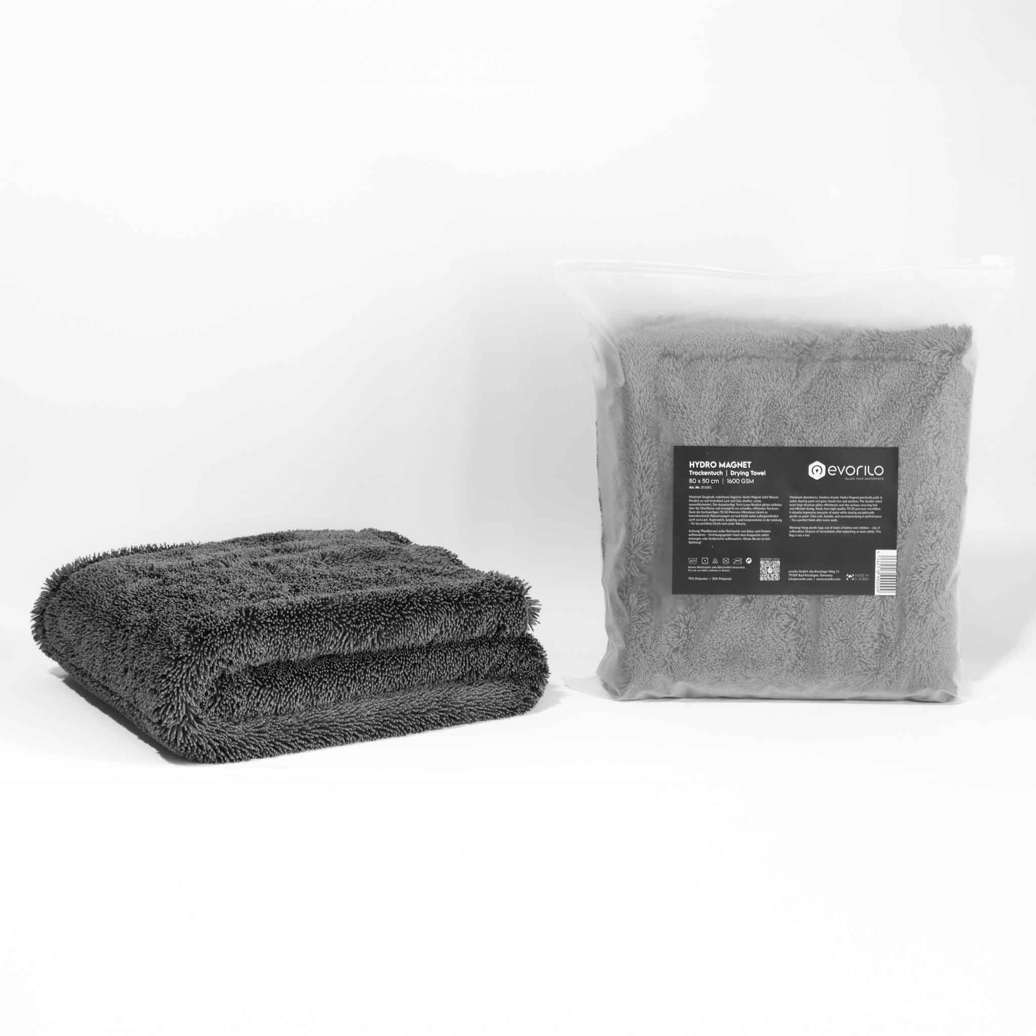 evorilo Hydro Magnet Trockentuch 1600 GSM in Grau, weiches Mikrofaserhandtuch ideal für Autopflege, zusammengefaltet neben Verpackung